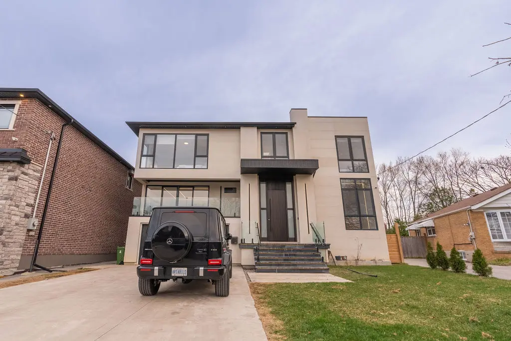An outer view of a newly designed modern house with a black Mercedes-Benz standing in front